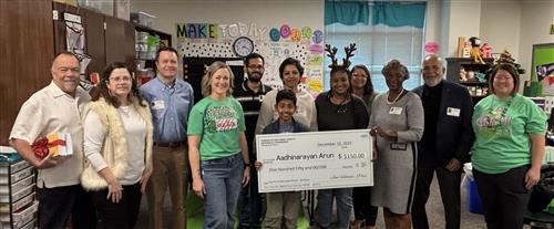 Essay winner with group and big check 